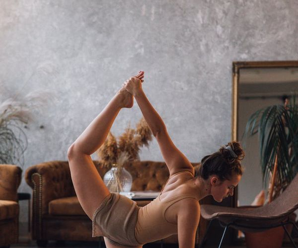 Person stretching on a yoga mat feeling energized and flexible.